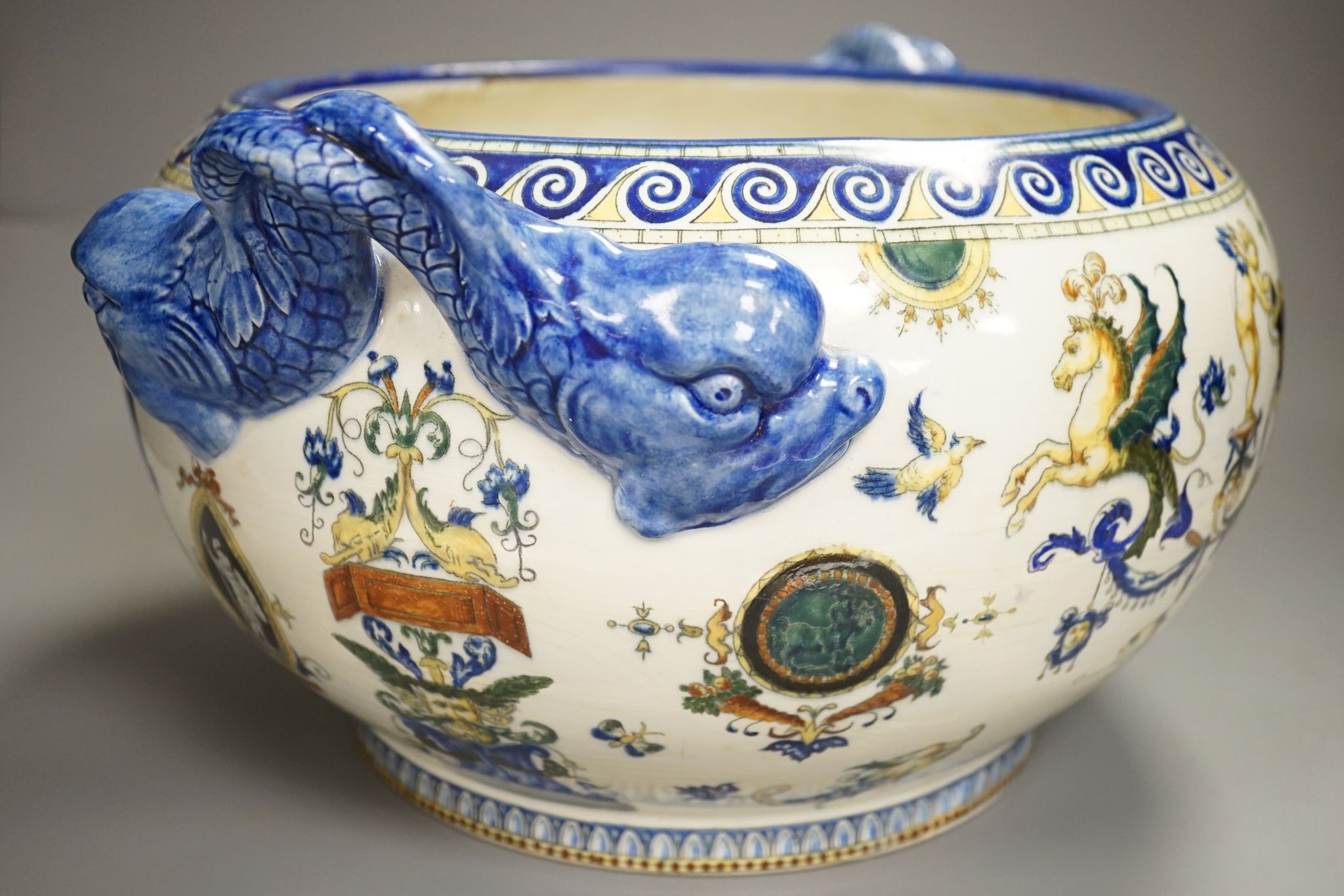 A French 19th century Gien pottery jardiniere with dolphin handles, 41 cms wide including handles.